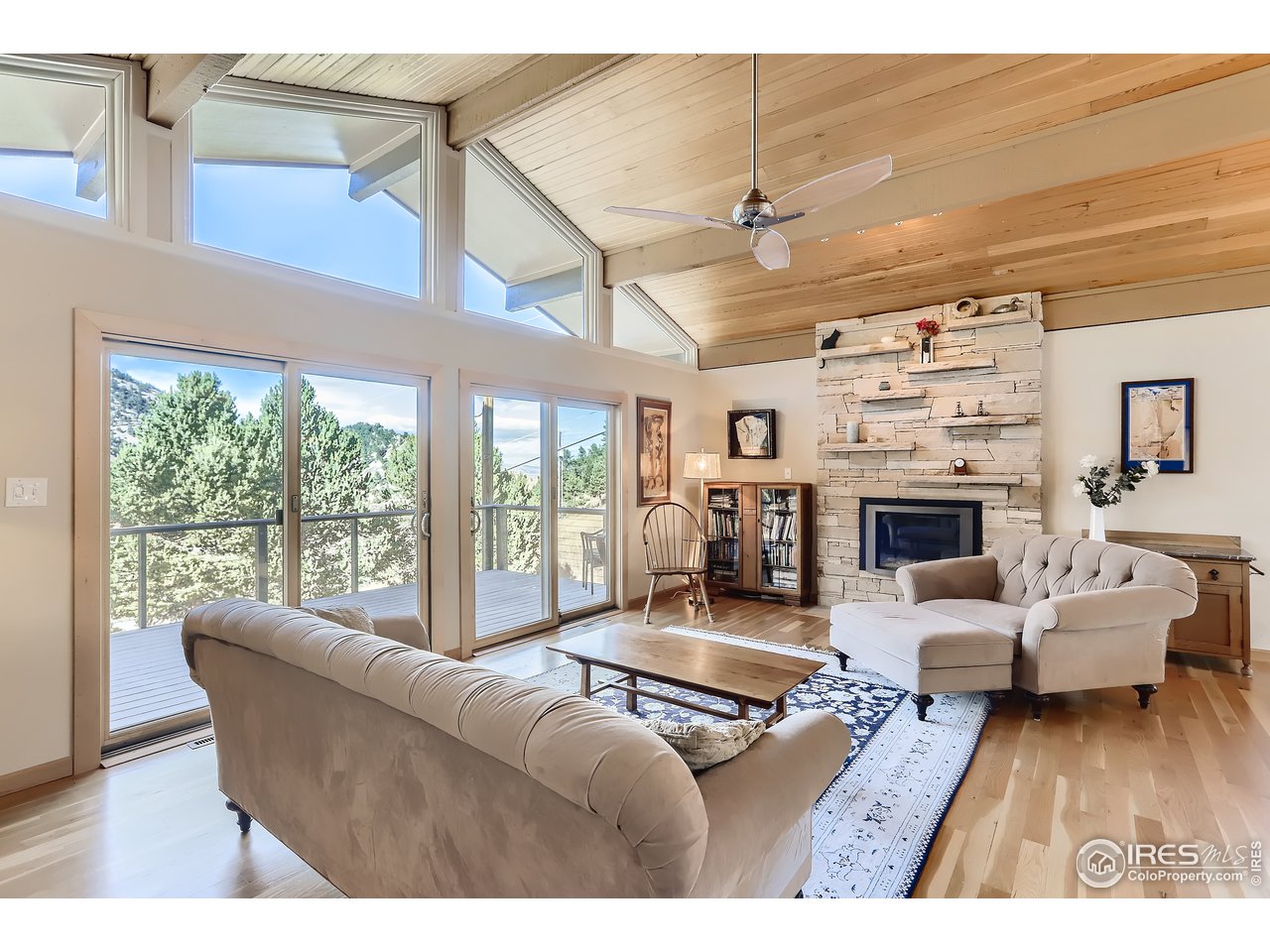 389 South Cedar Brook Road Boulder, CO 80304 - Photo 5 of 30 a living room with furniture large window and a fireplace