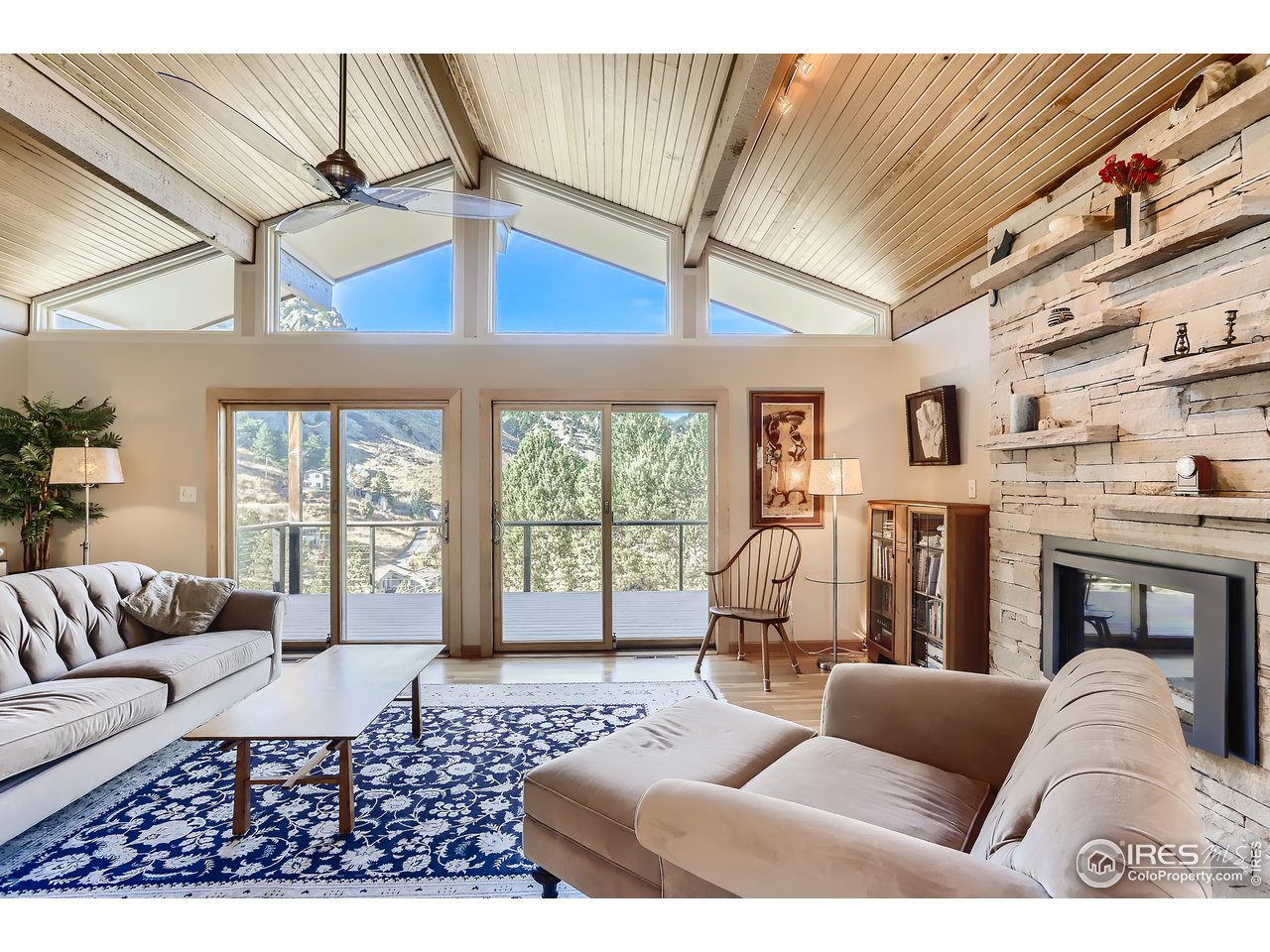 389 South Cedar Brook Road Boulder, CO 80304 - Photo 9 of 30 a living room with furniture fireplace and a large window