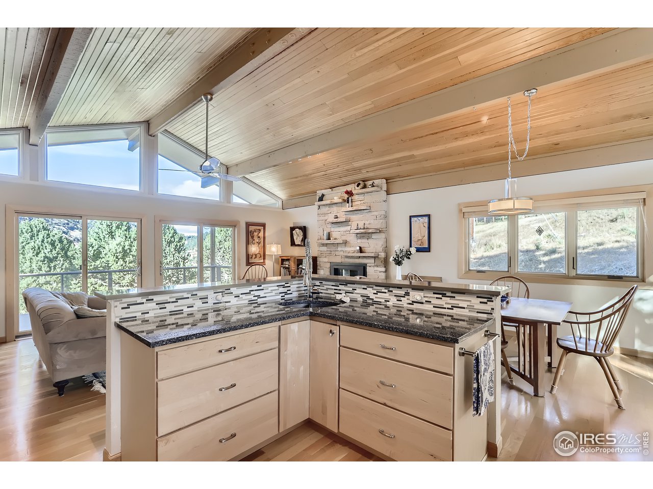 389 South Cedar Brook Road Boulder, CO 80304 - Photo 10 of 30 a kitchen with a stove a sink and white cabinets with wooden floor