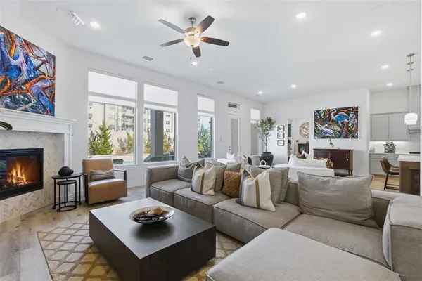 a living room with furniture fireplace and a window