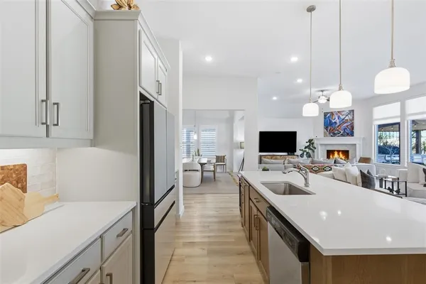 a large kitchen with a large counter top appliances and cabinets