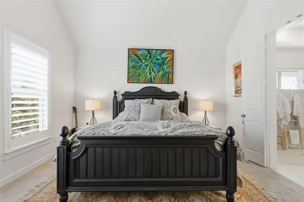 a bedroom with a bed and window