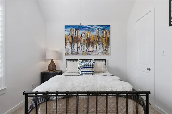 a bedroom with a bed and table