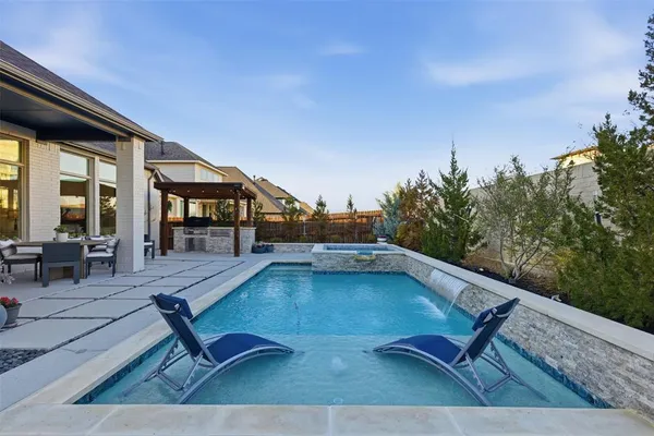 a swimming pool with outdoor seating and yard