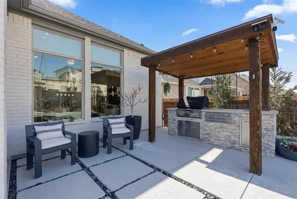 a view of a patio with dining table and chairs