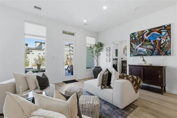 a living room with furniture a fireplace and a painting on the wall