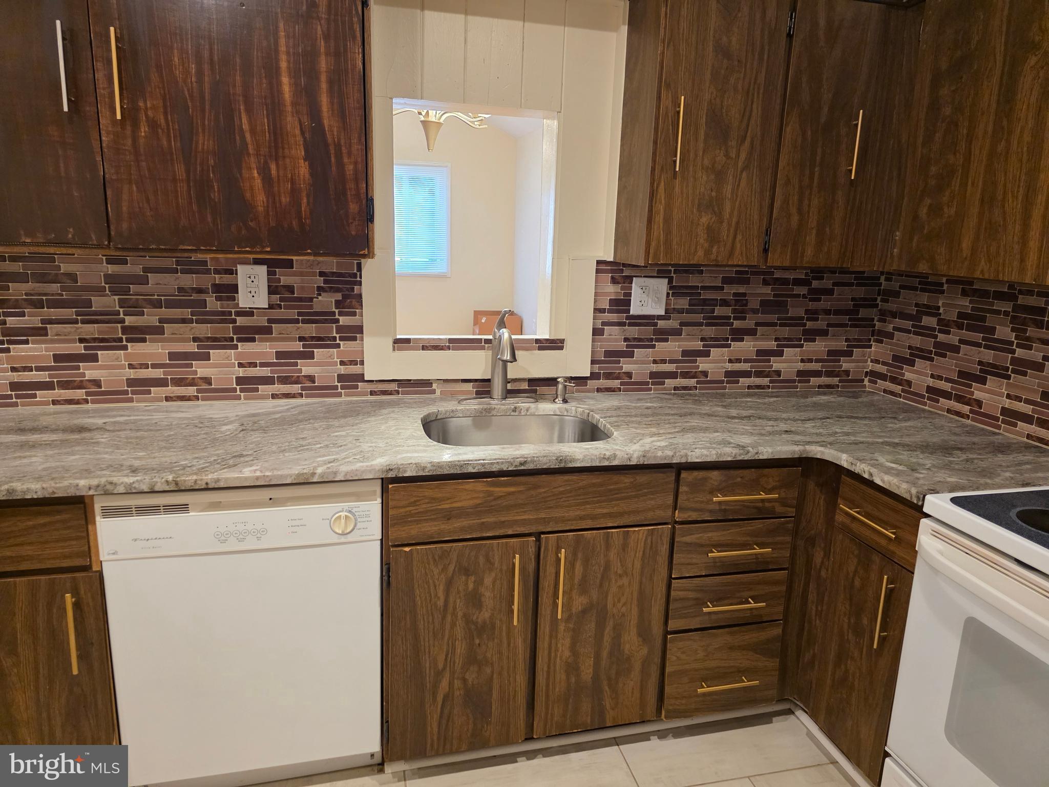 9 Georgetown Road Lindenwold, NJ 08021 - Photo 5 of 14 a kitchen with granite countertop wooden cabinets a sink and dishwasher