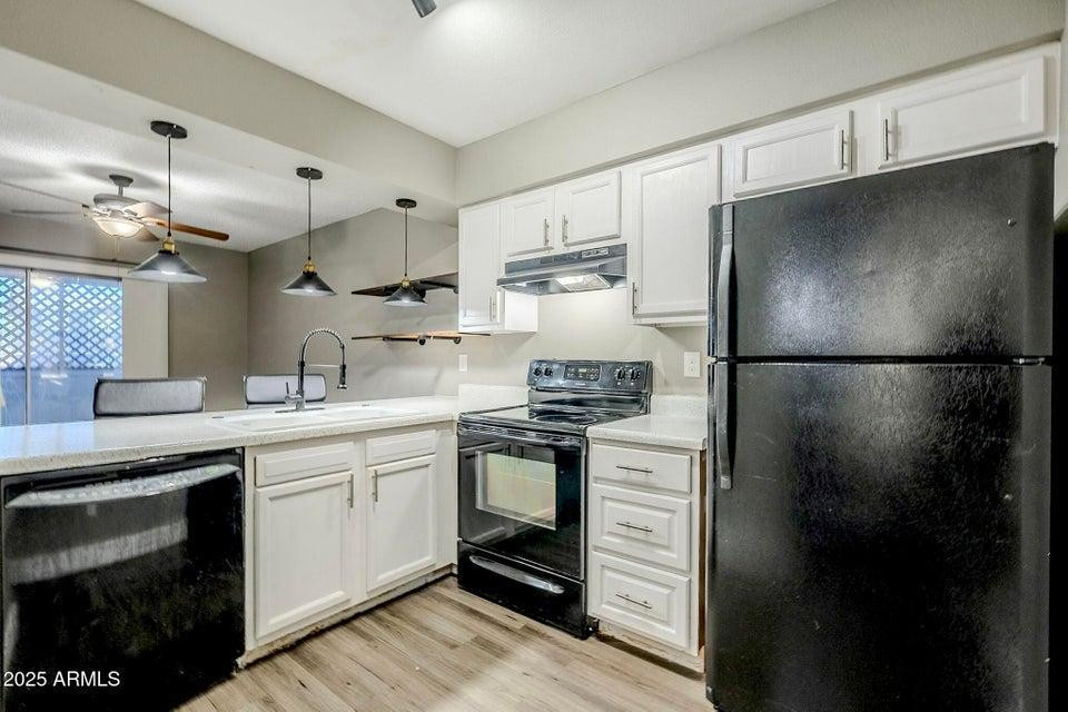 1826 N Spring, Unit 201 Mesa, AZ 85203 - Photo 6 of 17 a kitchen with a sink stainless steel appliances and cabinets