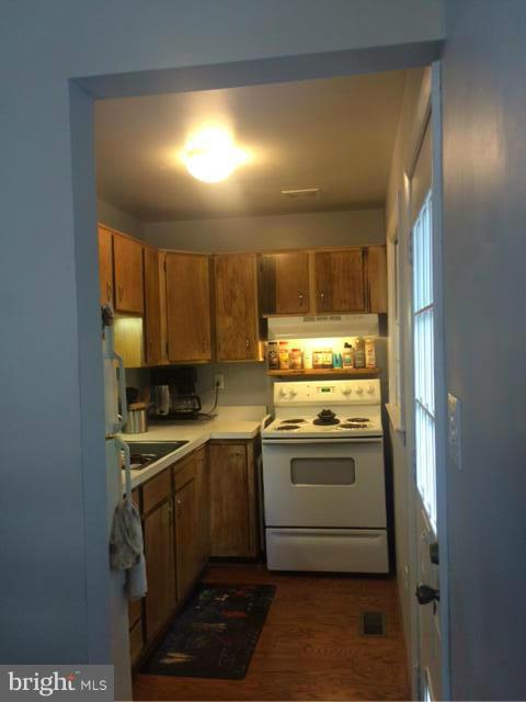403 Buffalo Road Mount Airy, MD 21771 - Photo 5 of 14 a kitchen with stainless steel appliances granite countertop a sink and a stove top oven