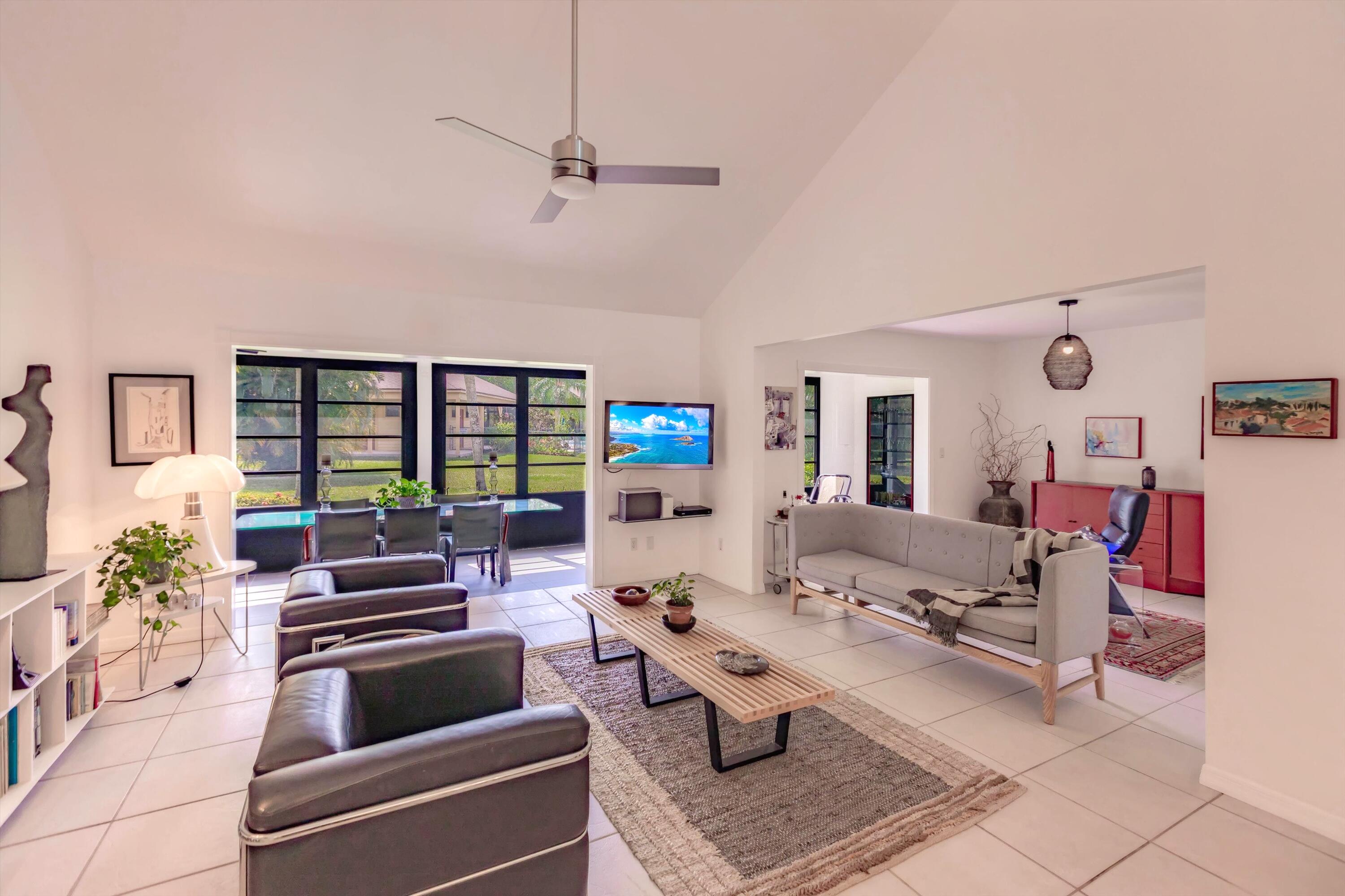 6115 Southeast Georgetown Place, Unit 1006 Hobe Sound, FL 33455 - Photo 1 of 68 a living room with furniture and a fireplace