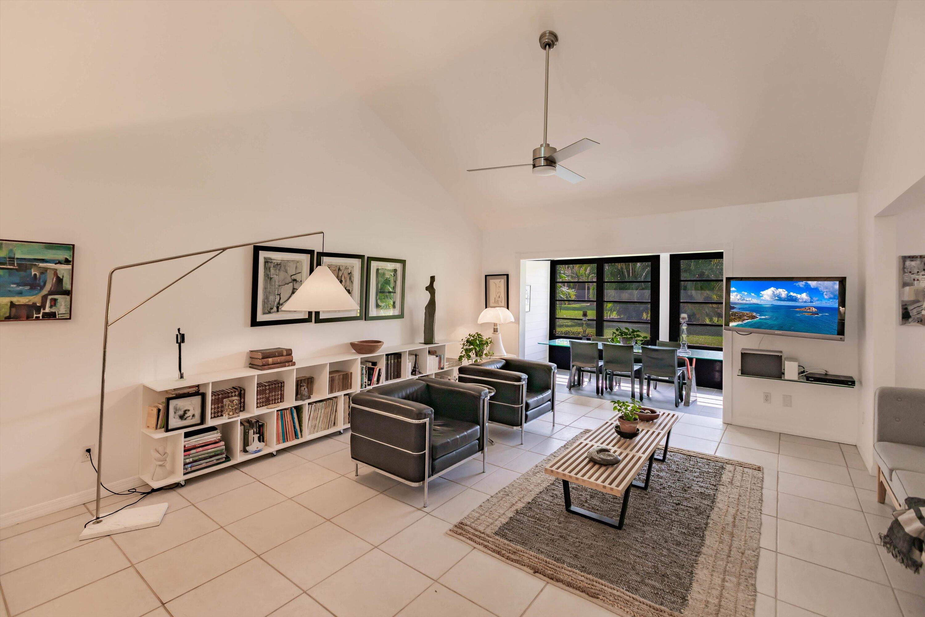 6115 Southeast Georgetown Place, Unit 1006 Hobe Sound, FL 33455 - Photo 11 of 68 a living room with furniture fireplace and flat screen tv