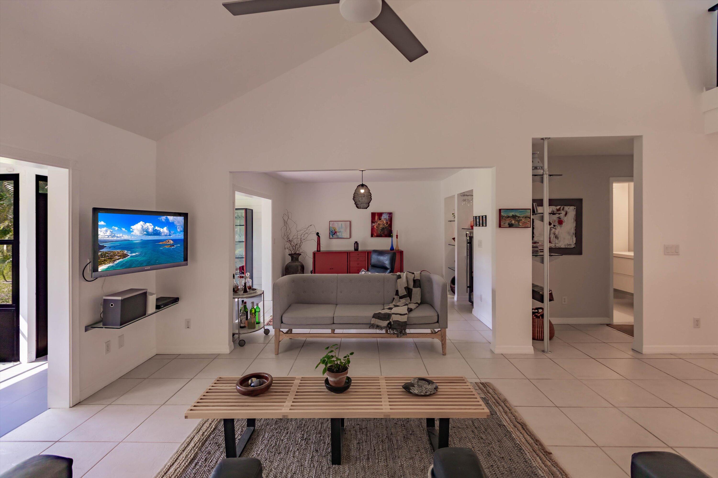 6115 Southeast Georgetown Place, Unit 1006 Hobe Sound, FL 33455 - Photo 12 of 68 a living room with furniture and a flat screen tv