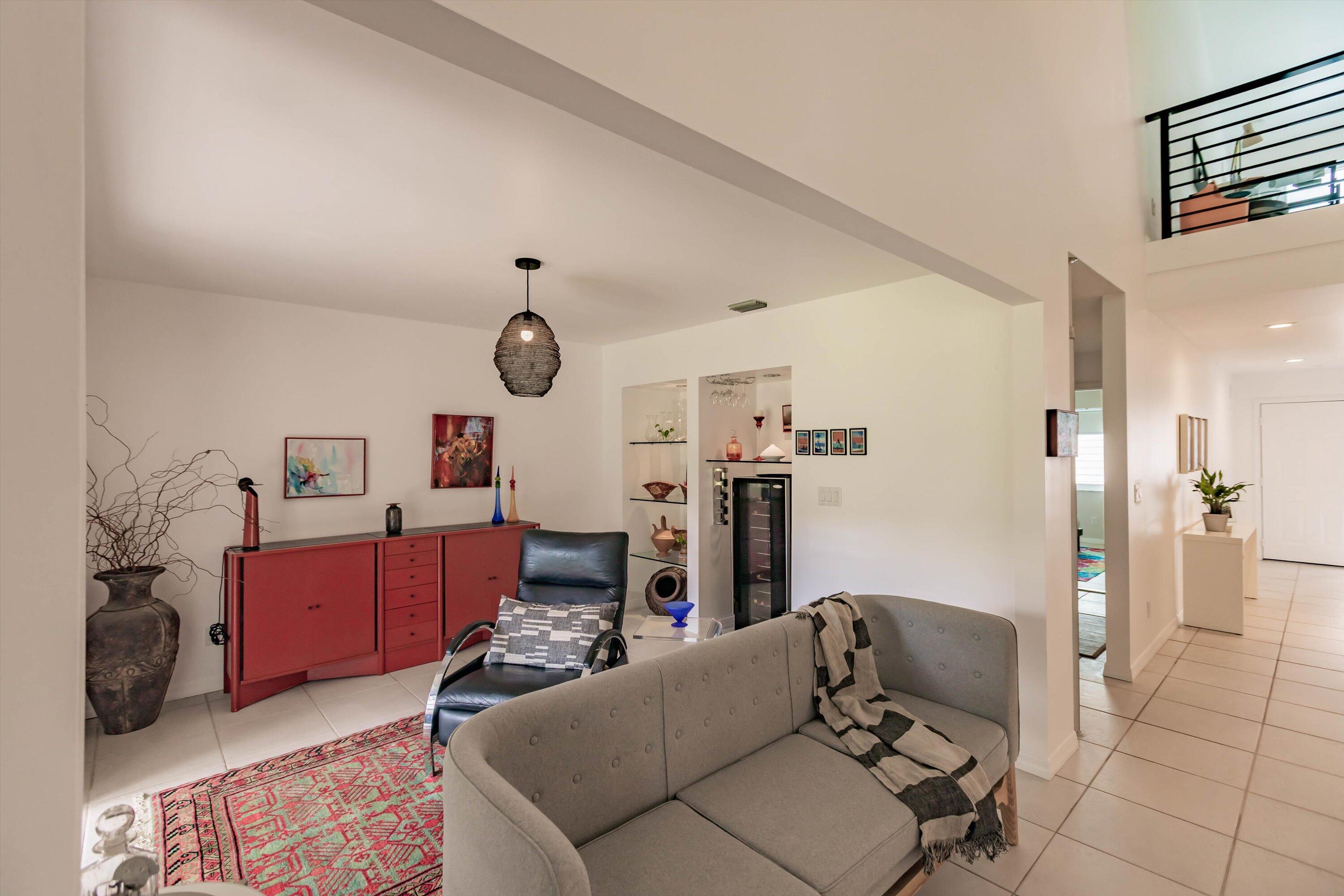 6115 Southeast Georgetown Place, Unit 1006 Hobe Sound, FL 33455 - Photo 13 of 68 a living room with furniture and a flat screen tv