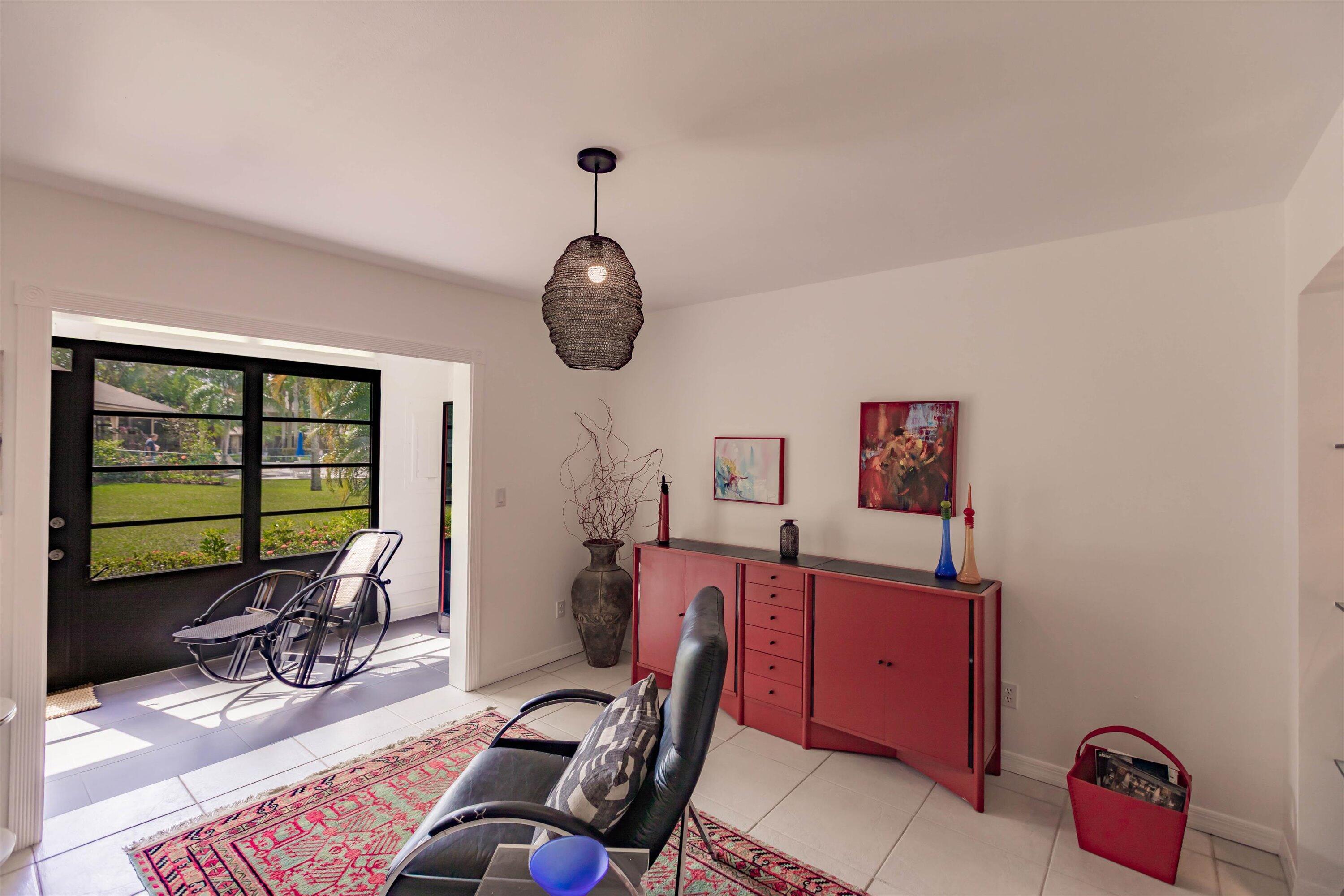 6115 Southeast Georgetown Place, Unit 1006 Hobe Sound, FL 33455 - Photo 15 of 68 a room with furniture a rug and a window