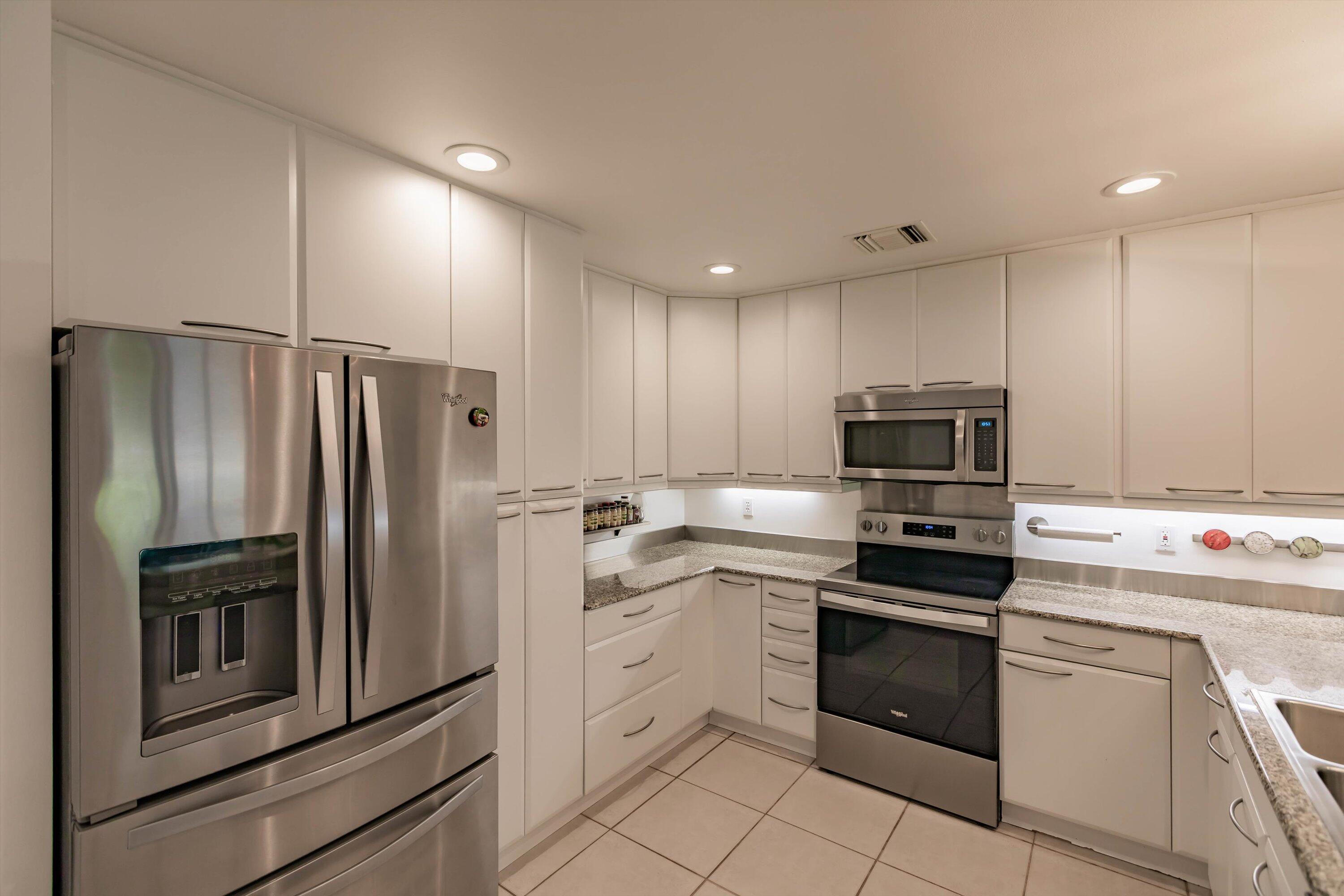6115 Southeast Georgetown Place, Unit 1006 Hobe Sound, FL 33455 - Photo 17 of 68 a kitchen with cabinets stainless steel appliances and a counter space