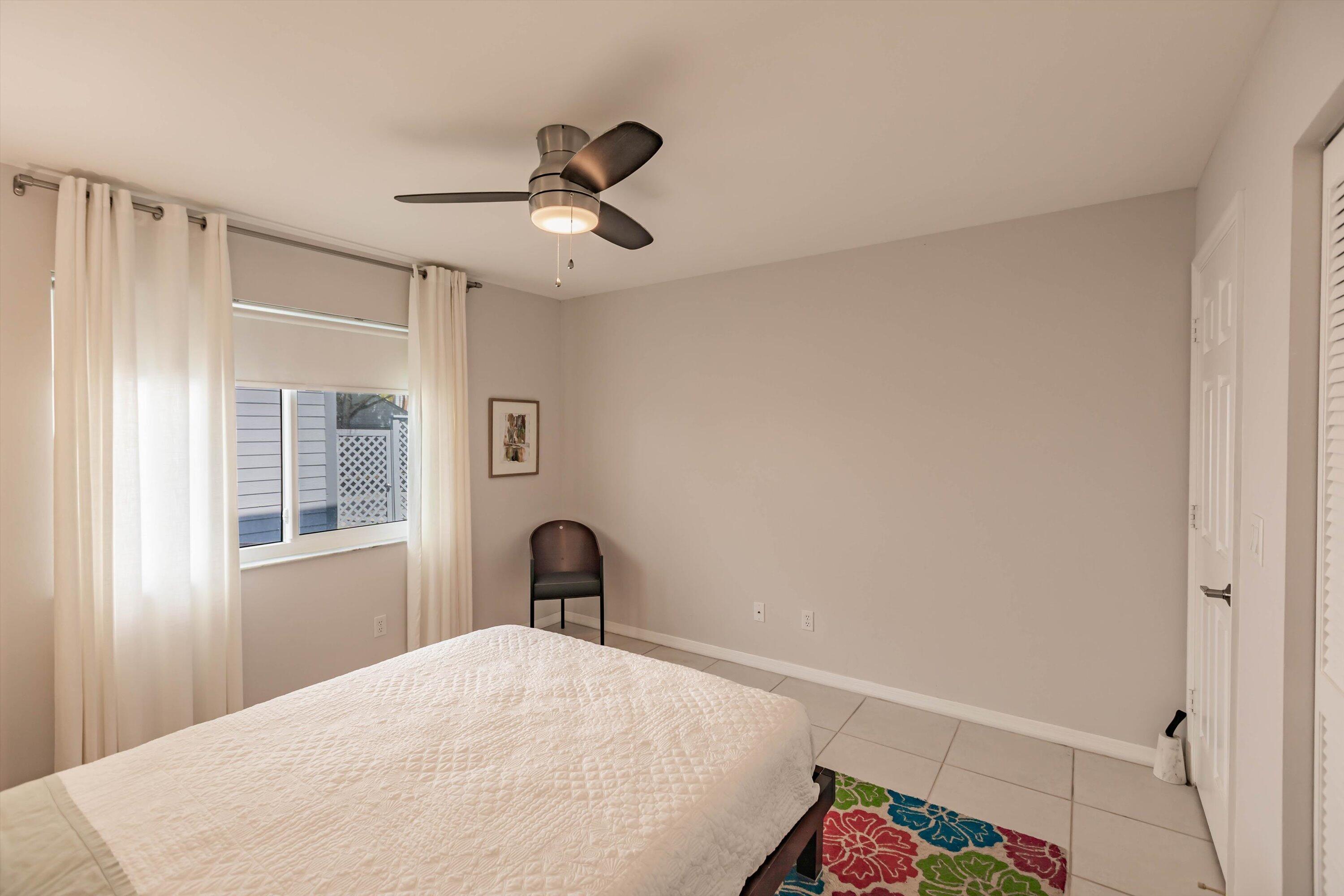 6115 Southeast Georgetown Place, Unit 1006 Hobe Sound, FL 33455 - Photo 24 of 68 a bedroom with a bed and a dresser