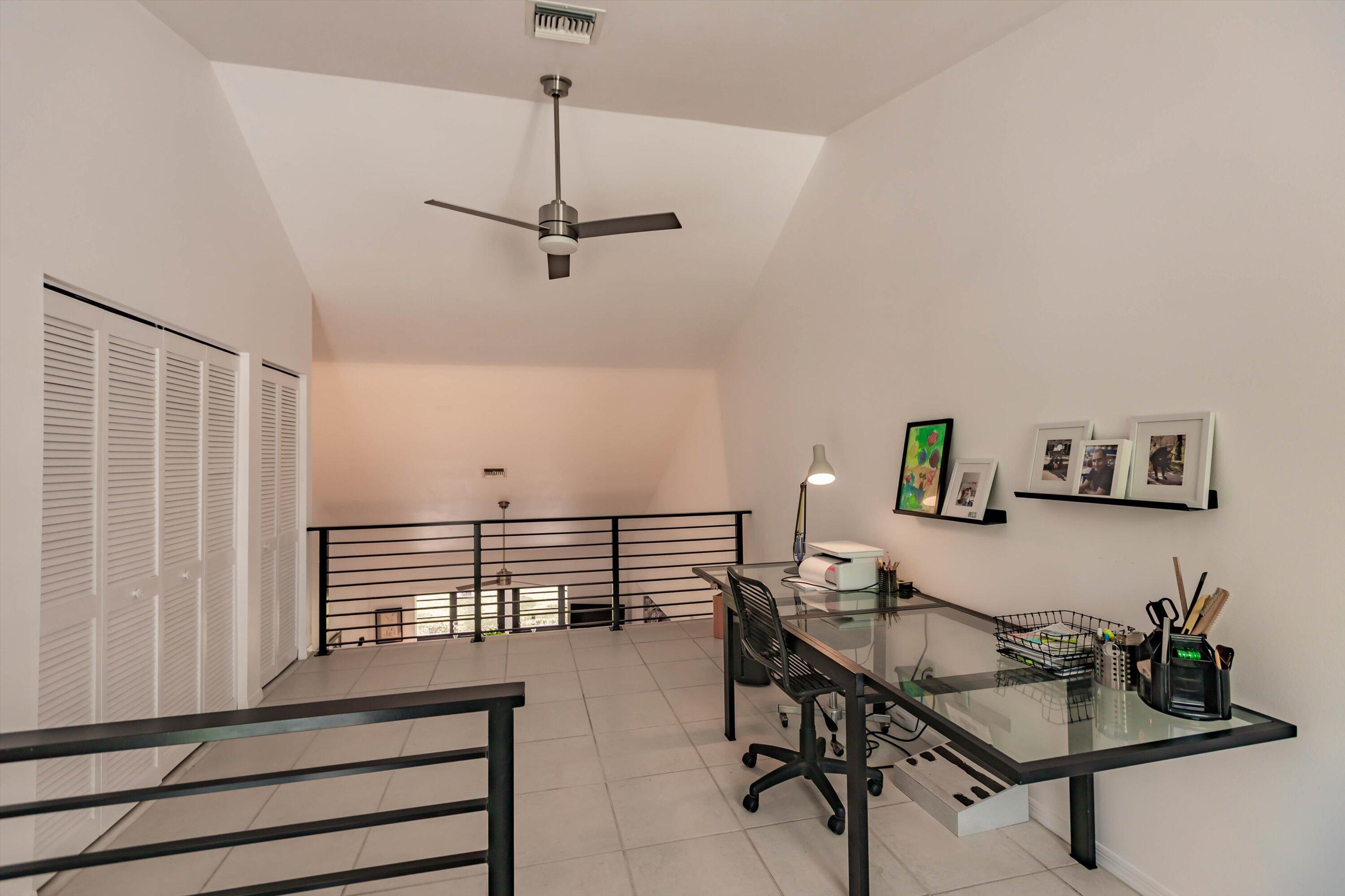 6115 Southeast Georgetown Place, Unit 1006 Hobe Sound, FL 33455 - Photo 27 of 68 a view of a workspace with furniture