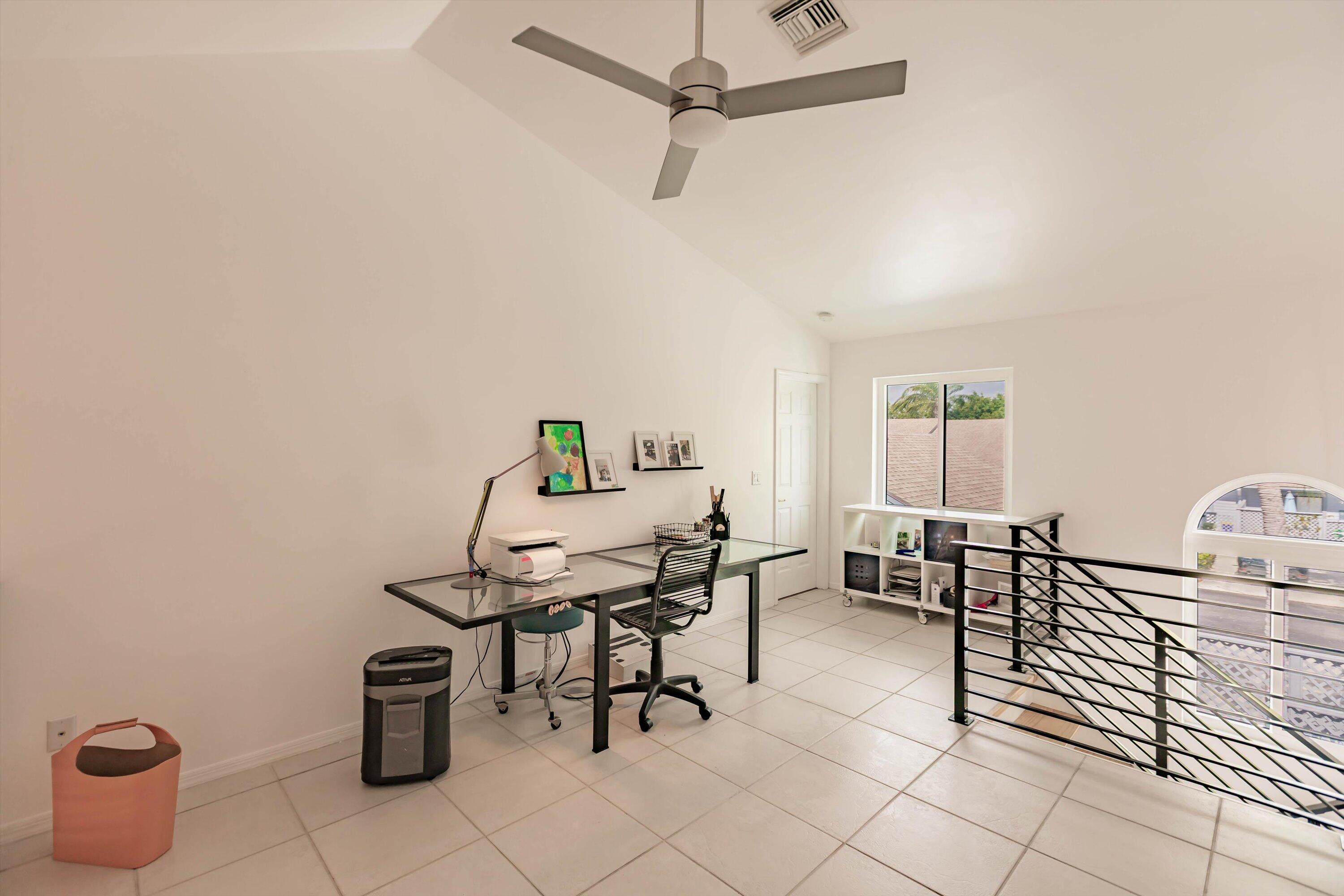 6115 Southeast Georgetown Place, Unit 1006 Hobe Sound, FL 33455 - Photo 28 of 68 a view of a workspace with furniture