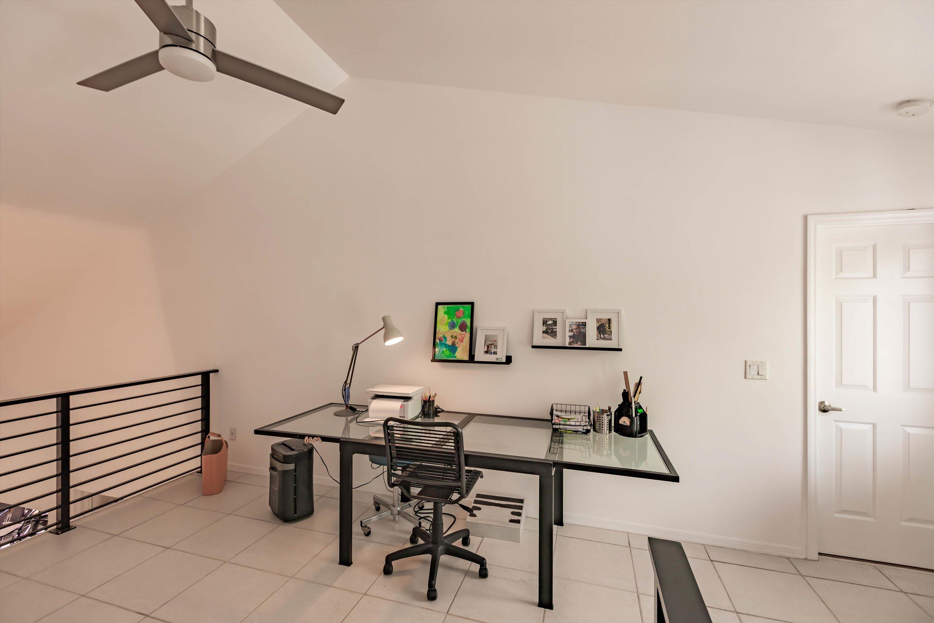 6115 Southeast Georgetown Place, Unit 1006 Hobe Sound, FL 33455 - Photo 30 of 68 a view of a workspace with furniture
