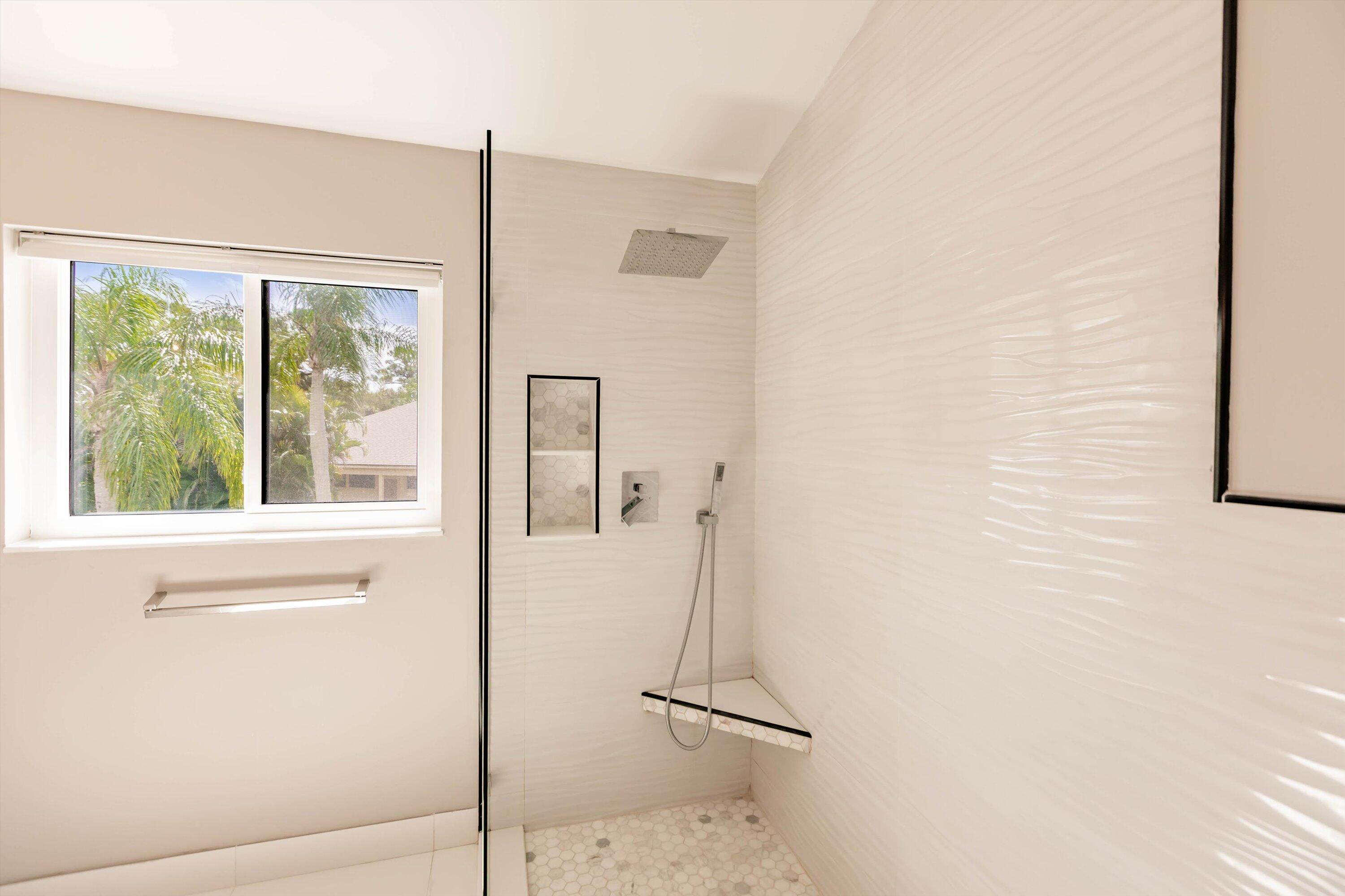 6115 Southeast Georgetown Place, Unit 1006 Hobe Sound, FL 33455 - Photo 35 of 68 a bathroom with a shower and a window