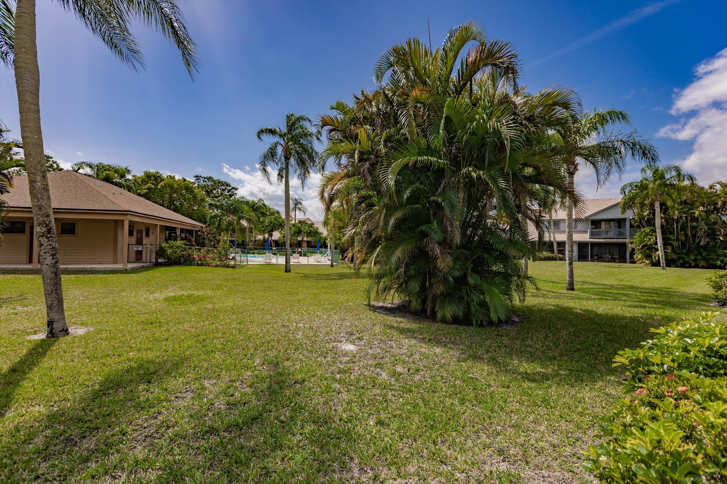 6115 Southeast Georgetown Place, Unit 1006 Hobe Sound, FL 33455 - Photo 43 of 68 a view of a house with a yard