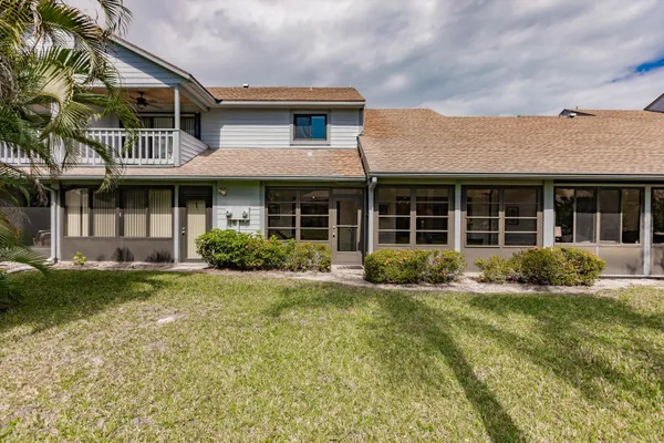 a house with palm tree in front of it