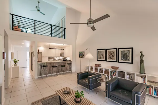 a living room with furniture and kitchen view