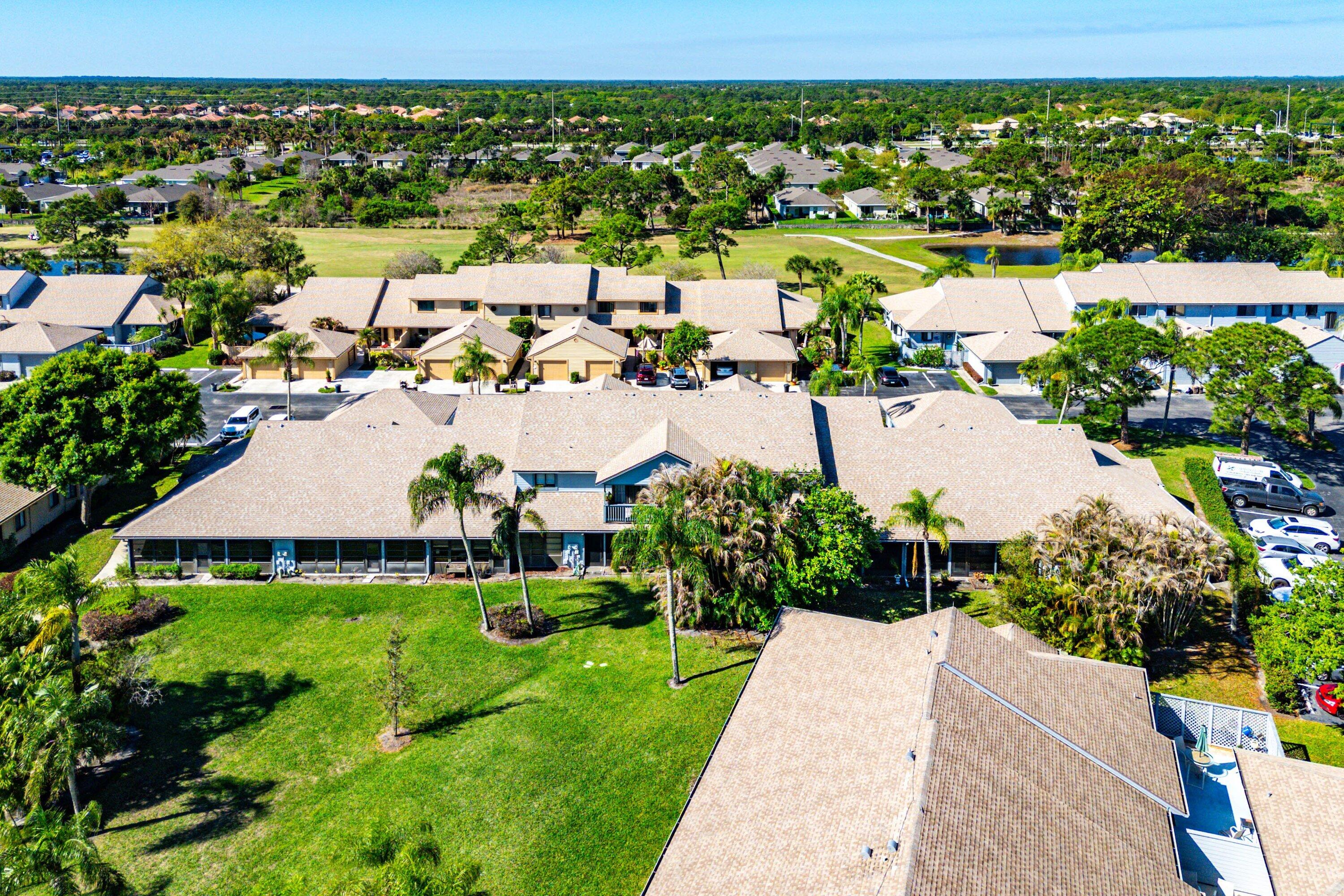 6115 Southeast Georgetown Place, Unit 1006 Hobe Sound, FL 33455 - Photo 60 of 68 an aerial view of residential houses with outdoor space and swimming pool