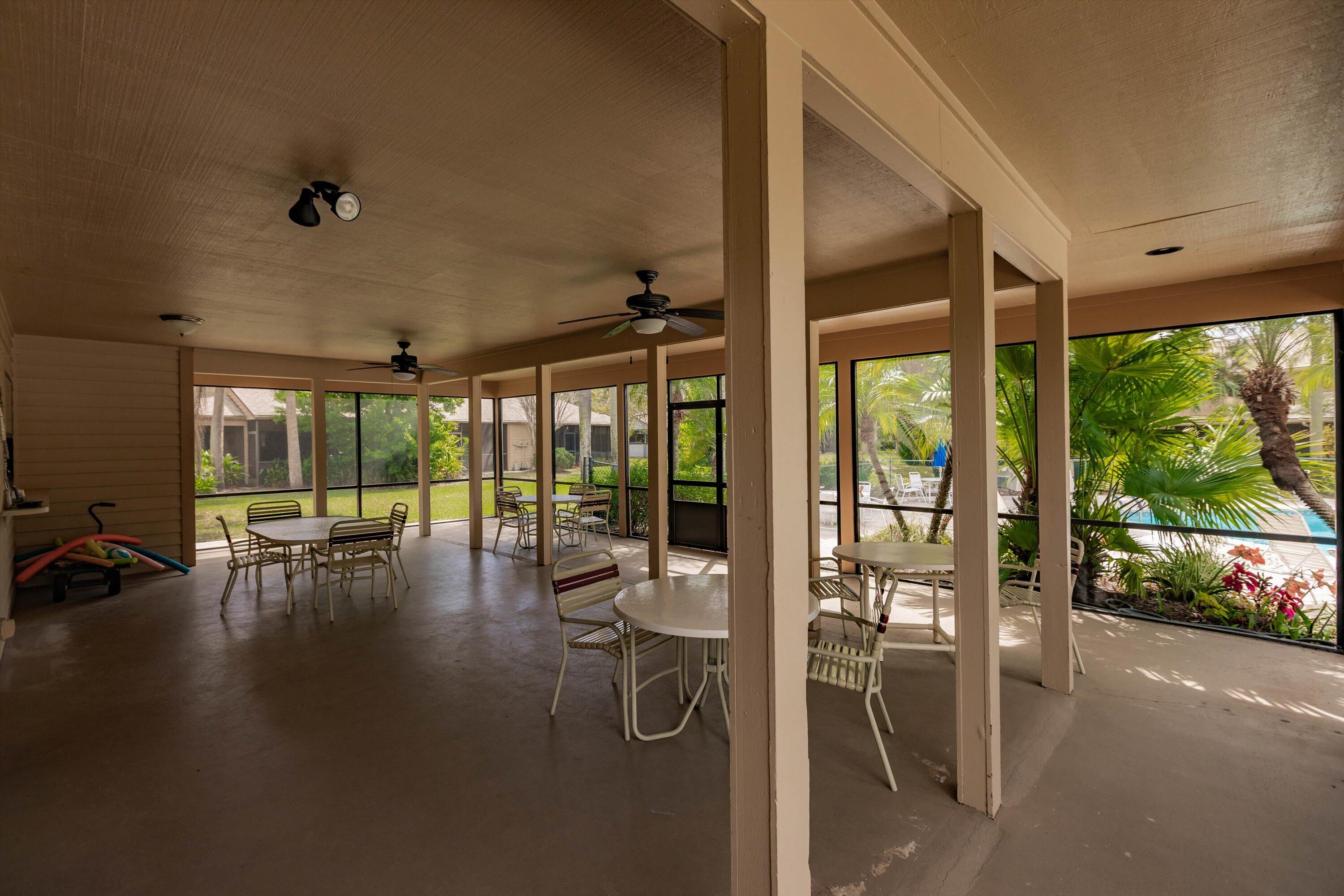 6115 Southeast Georgetown Place, Unit 1006 Hobe Sound, FL 33455 - Photo 66 of 68 a view of a dining room with furniture water view and a floor to ceiling window