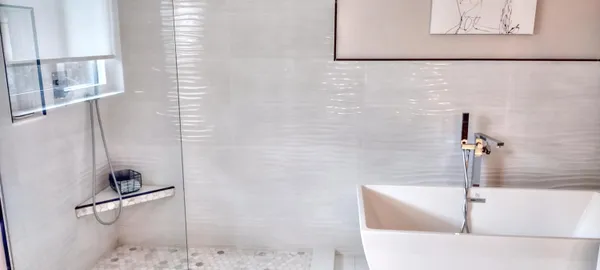 a bath tub sitting next to a white shower