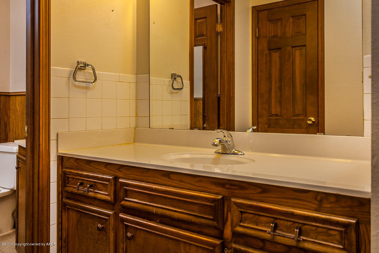 7002 Euclid Street Amarillo, TX 79110 - Photo 14 of 23 a bathroom with a sink a mirror and a shower