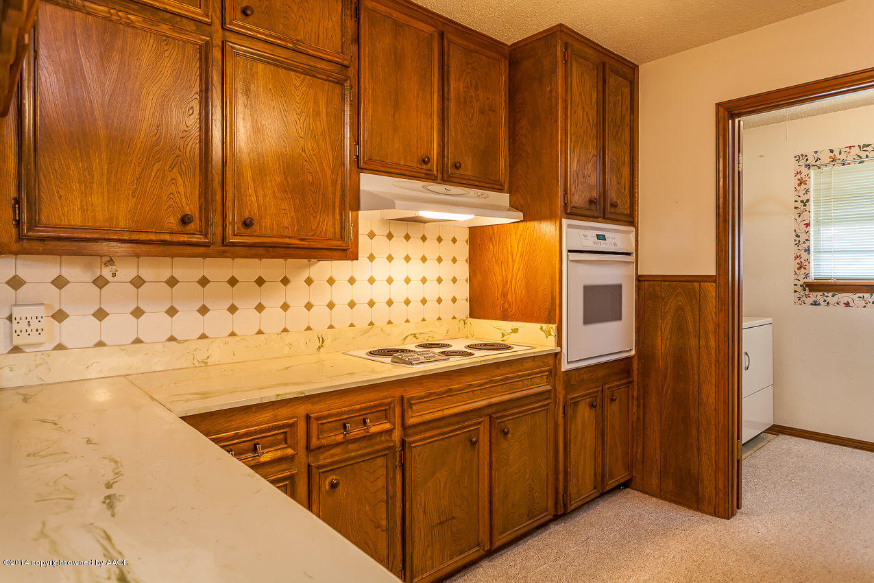 7002 Euclid Street Amarillo, TX 79110 - Photo 8 of 23 a kitchen with stainless steel appliances a stove and a refrigerator
