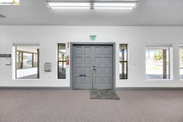 a view of a livingroom with furniture and a flat screen tv