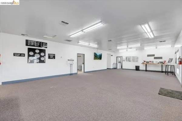 a kitchen with stainless steel appliances granite countertop a sink cabinets and wooden floor