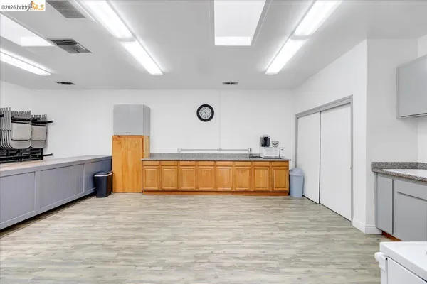 a kitchen with stainless steel appliances a refrigerator and wooden floor