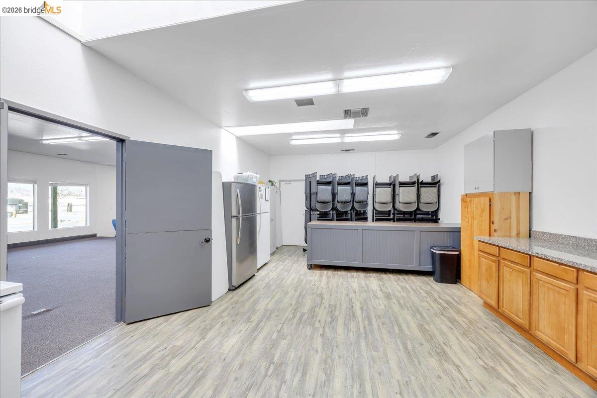 14326 Tuolumne Road Sonora, CA 95370 - Photo 28 of 48 a kitchen with stainless steel appliances a refrigerator and wooden floor