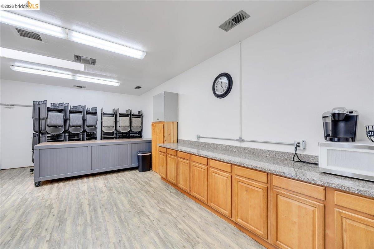 14326 Tuolumne Road Sonora, CA 95370 - Photo 29 of 48 a large kitchen with stainless steel appliances a large counter top a stove and a wooden floors