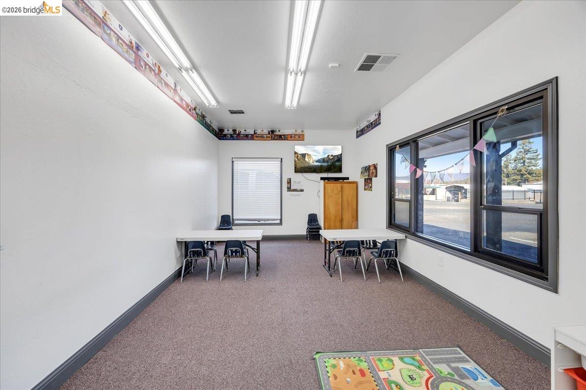 14326 Tuolumne Road Sonora, CA 95370 - Photo 39 of 48 a view of a dining room with furniture a chandelier and wooden floor