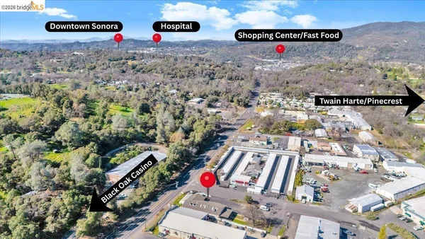an aerial view of a house with swimming pool and sitting area