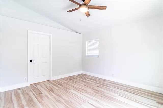 a view of a room with a ceiling fan