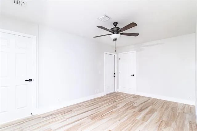 a view of a room with a ceiling fan