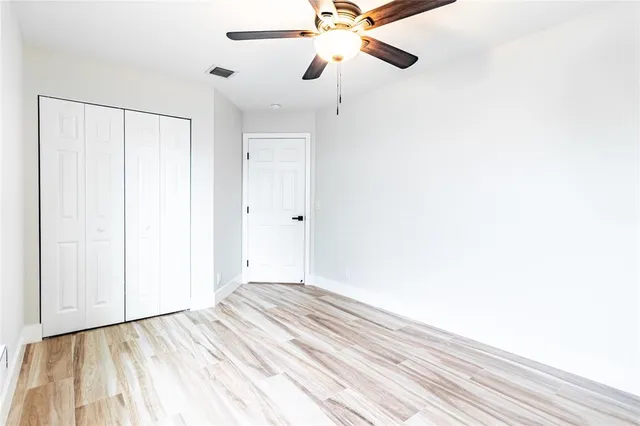 a view of a room with a ceiling fan