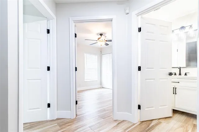 a view of a hallway with wooden floor