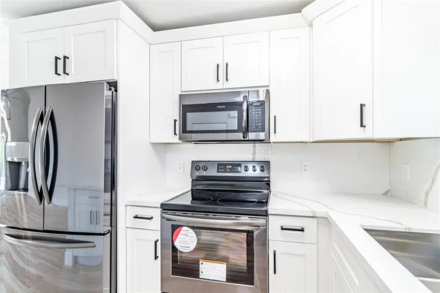 a kitchen with a refrigerator stove and microwave