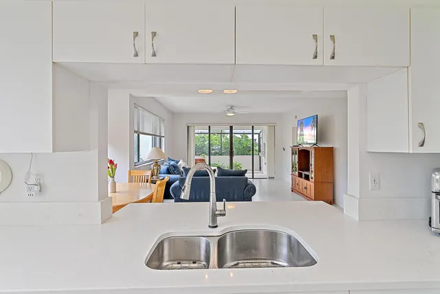 a kitchen with sink refrigerator and window