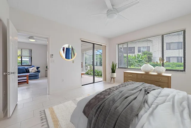 a bed room with a bed and a large window