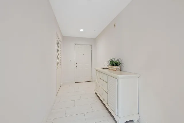 a hallway with white cabinets