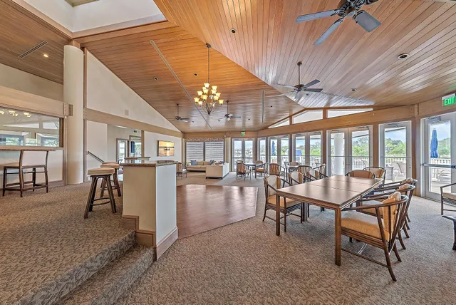 a dining room with wooden floor table and chairs