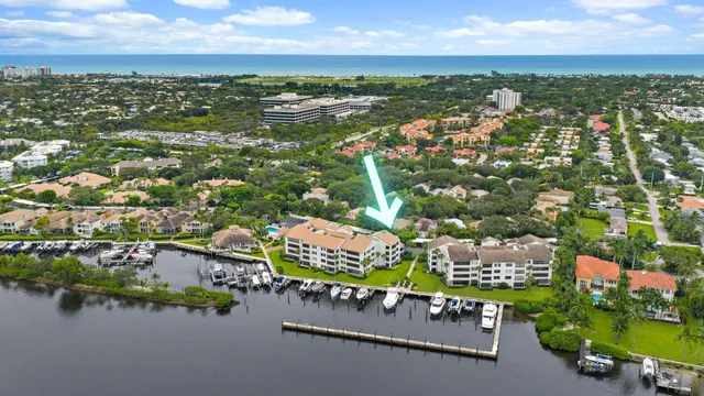 an aerial view of residential houses with outdoor space and lake view