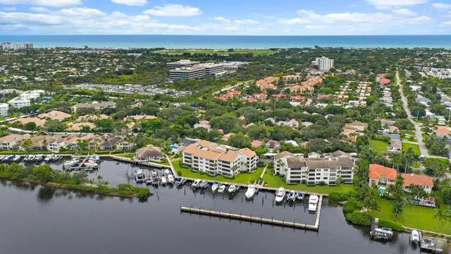 an aerial view of residential houses with outdoor space and lake view